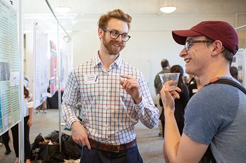 Student and professor talking at poster board